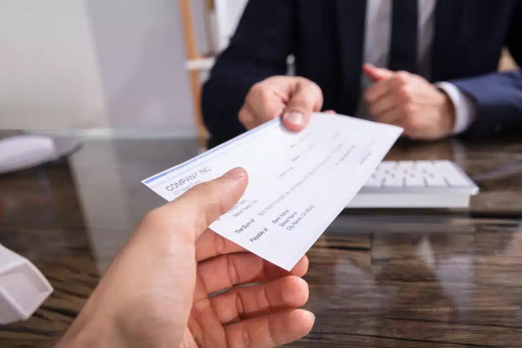 What are the Risks of Signing a Check to Someone Else?